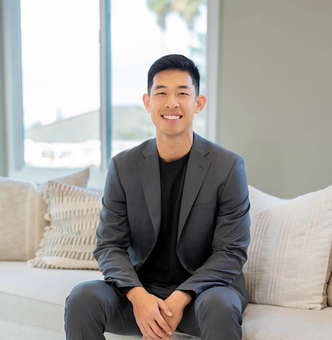 Portrait of Andre Wang seated in a living room